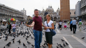 Feeding pigeons in Venice's St. Mark's Square during the 2007 Italy trip, with the Basilica and Campanile visible in the background